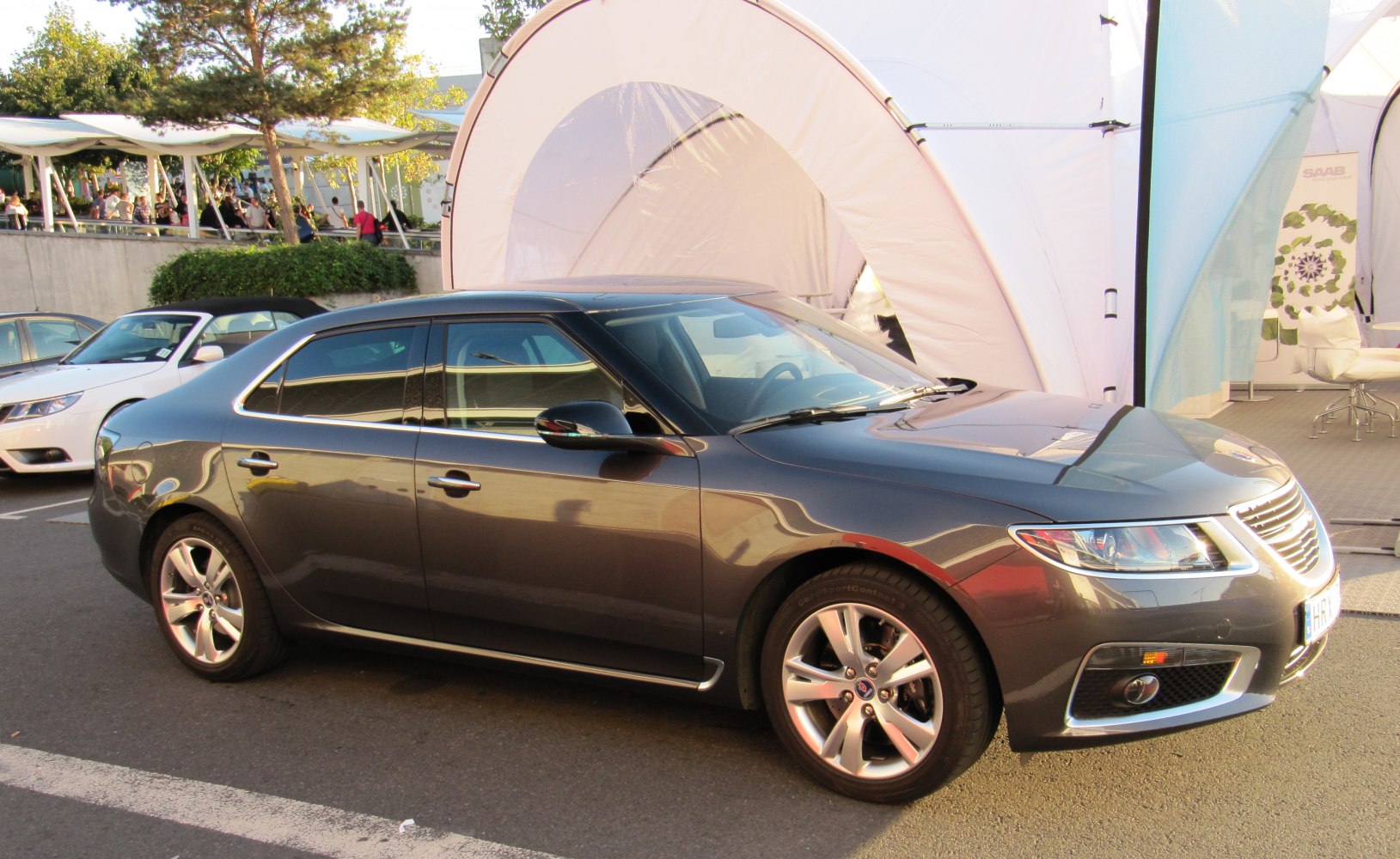 Sleek sedan side profile with alloy wheels and modern front headlights