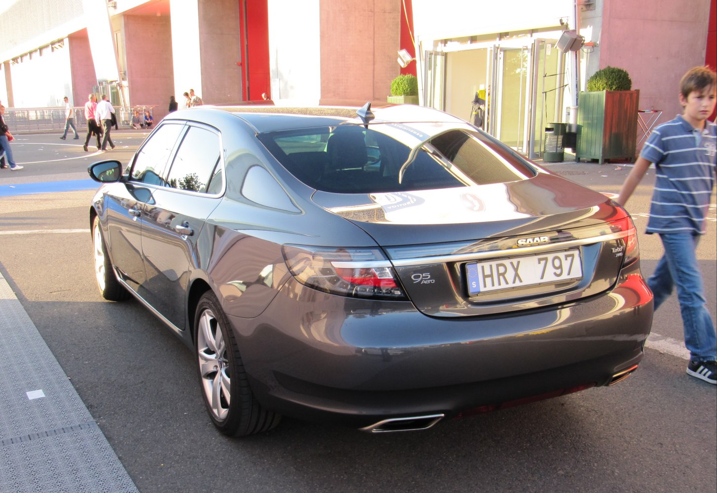 Rear view of sedan with taillights, dual exhaust, and Turbo AWD badge