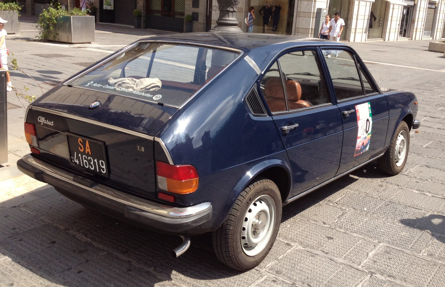 Rear view of vintage hatchback with distinctive rear window and tail lights