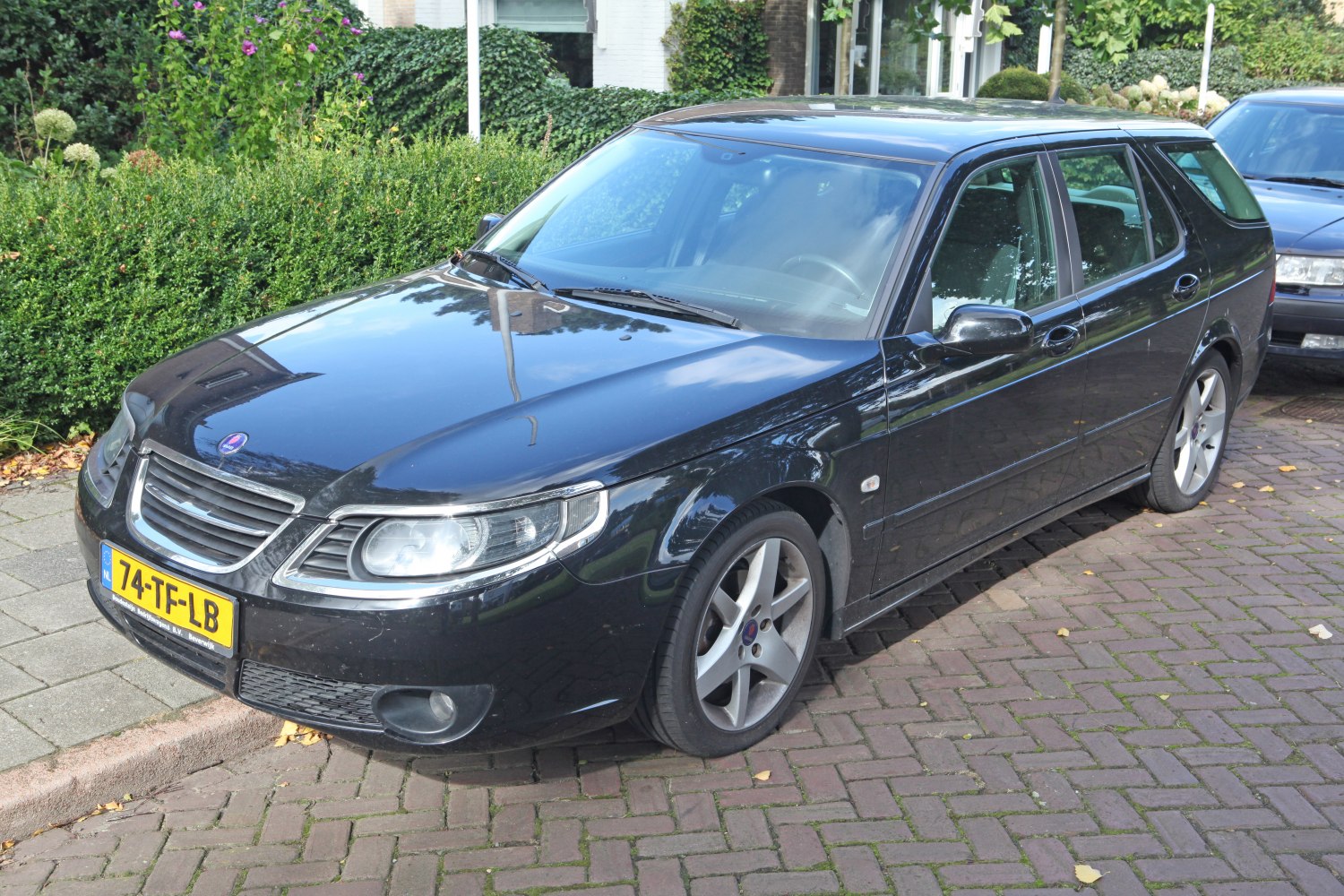 Black station wagon with alloy wheels and sleek front side profile