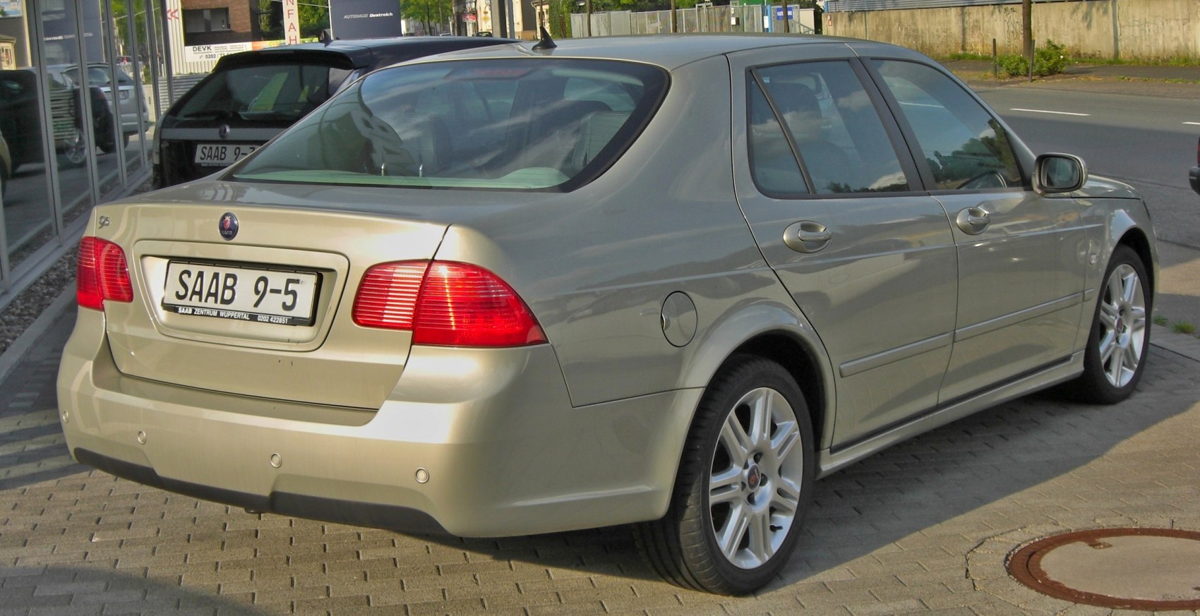 Rear view of a sleek sedan with distinctive taillights and alloy wheels