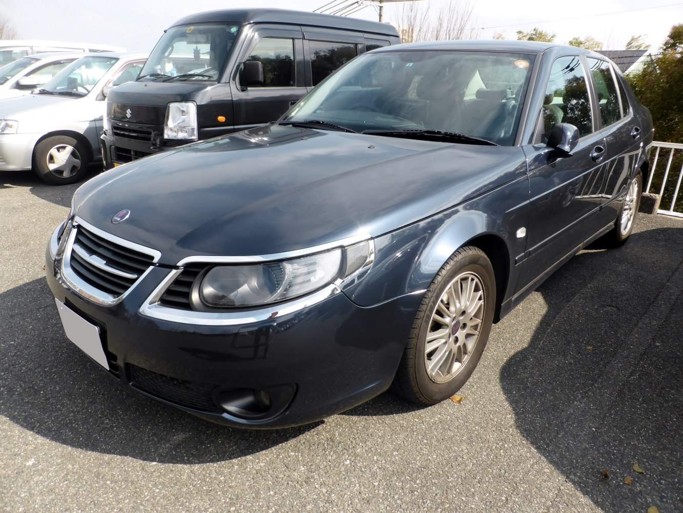 Front view of a sedan with chrome grille and clear headlights.