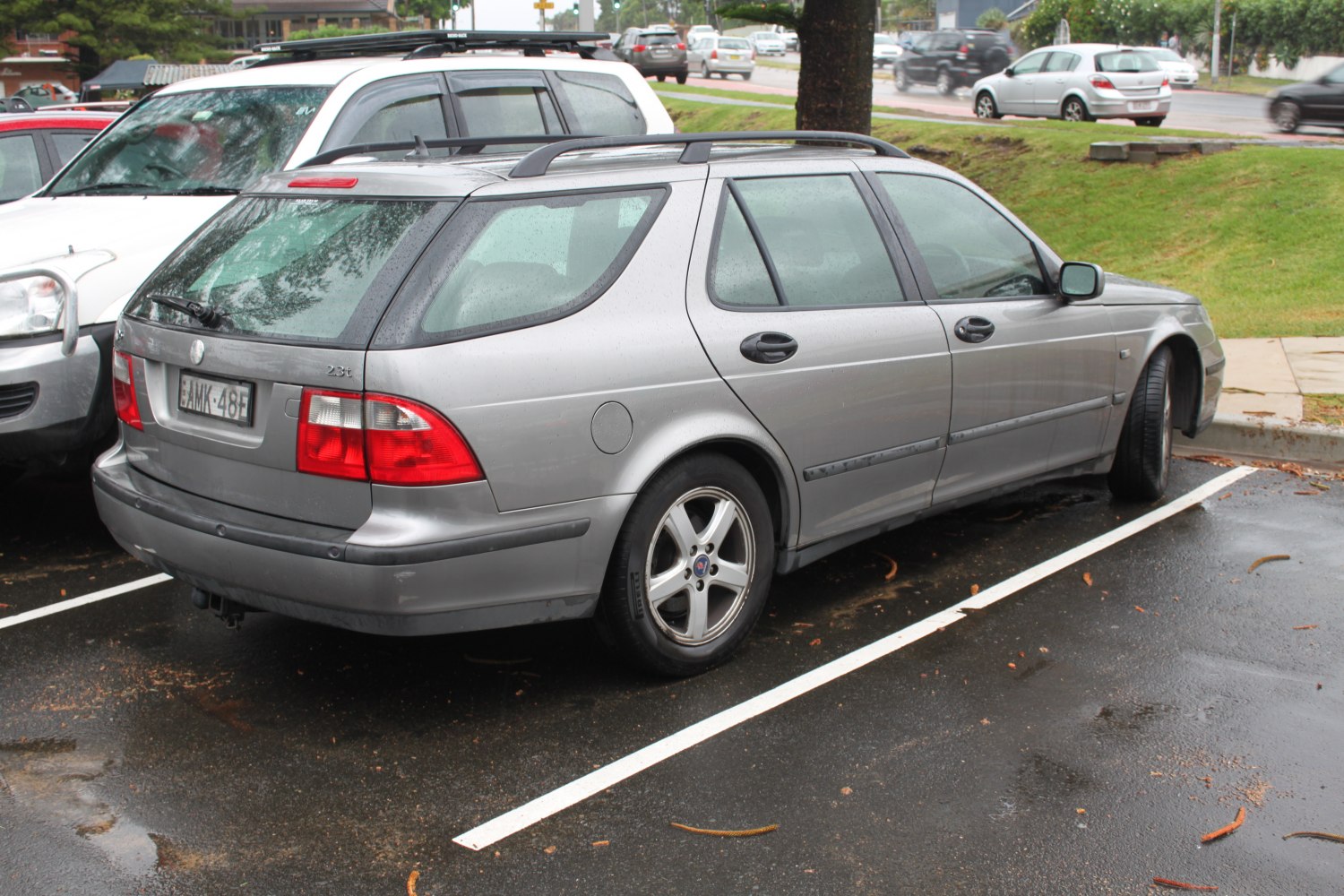 Rear-side view of a station wagon with roof rails and alloy wheels
