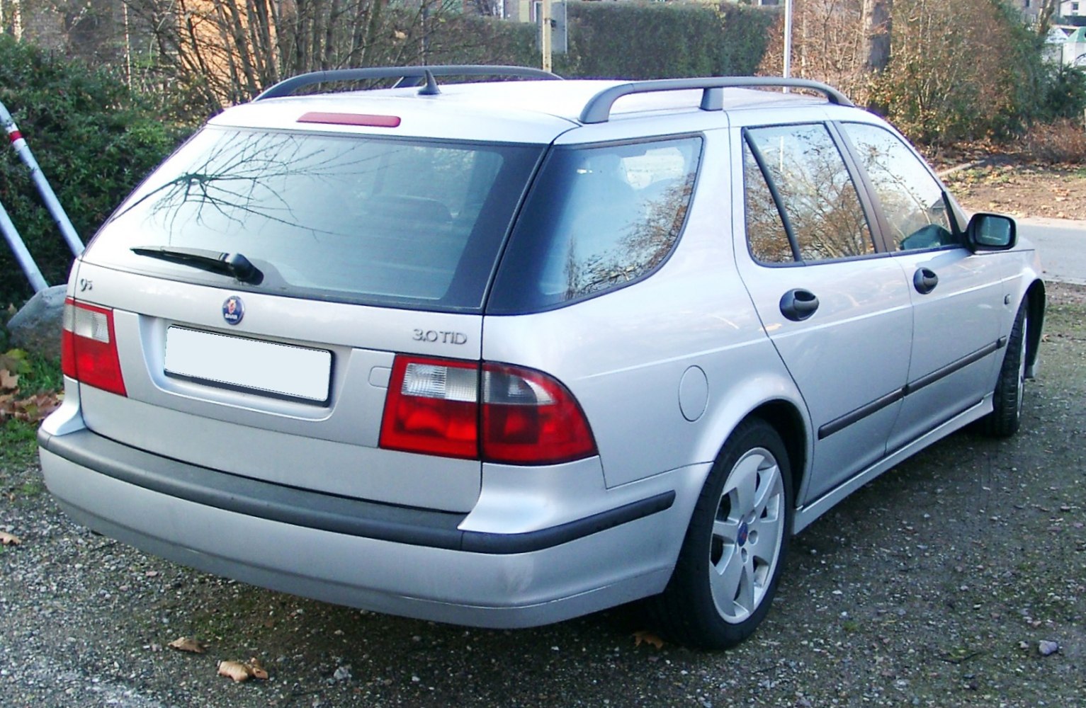 Rear and side view of silver station wagon with roof rails and alloy wheels