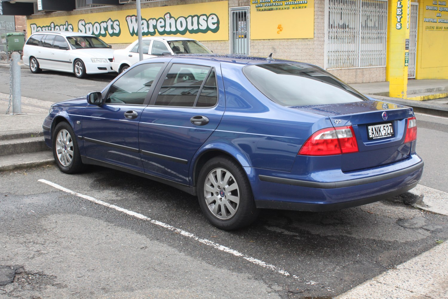Rear view of a blue sedan with distinct taillights and simple rear design.