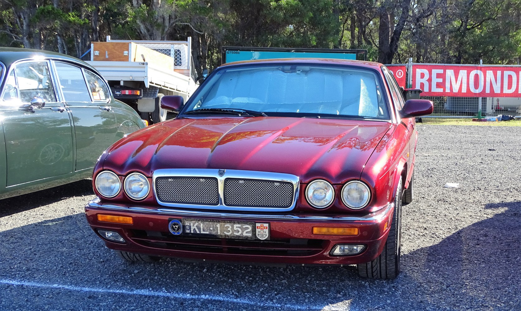 Front view with quad circular headlights and chrome mesh grille