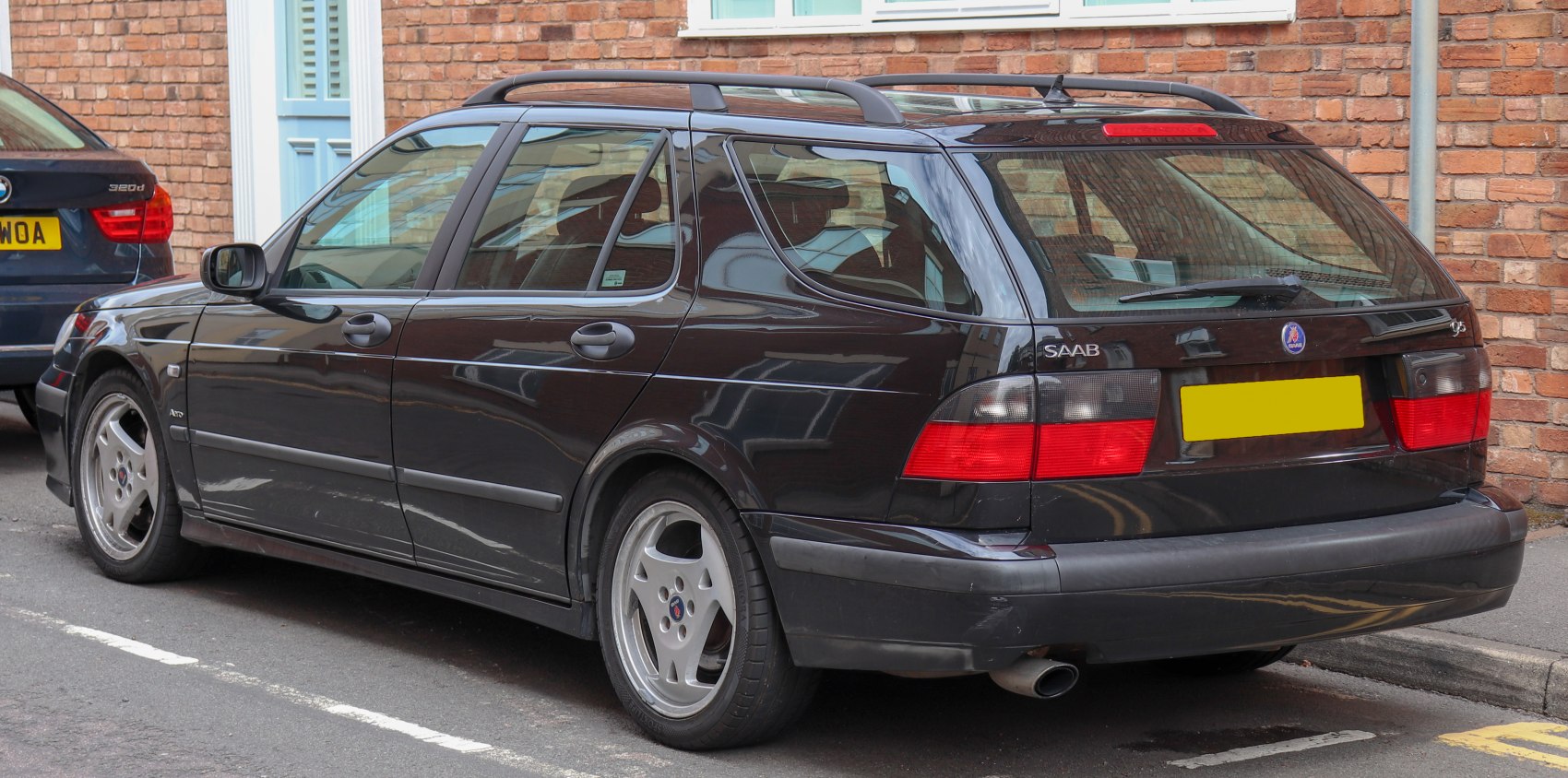 Rear three-quarter view of station wagon with roof rails and distinctive taillights