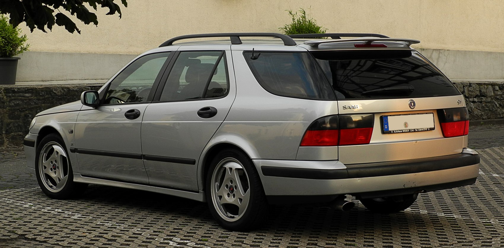 Silver station wagon with roof rails and rear spoiler