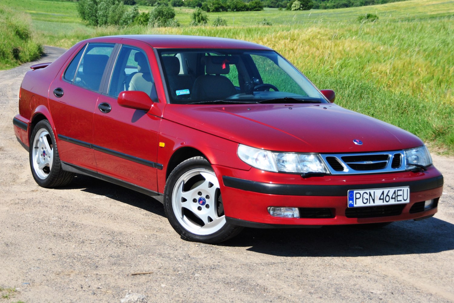 Red sedan from front-side angle with classic 1997-2001 design