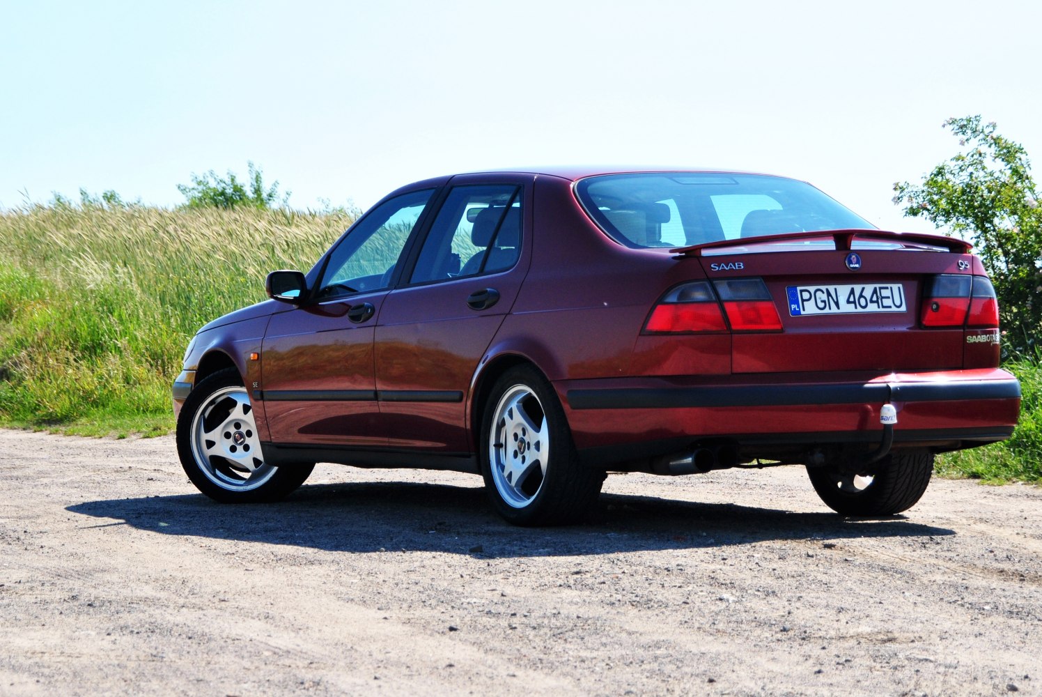 Rear three-quarter view of a sedan with alloy wheels and rear spoiler