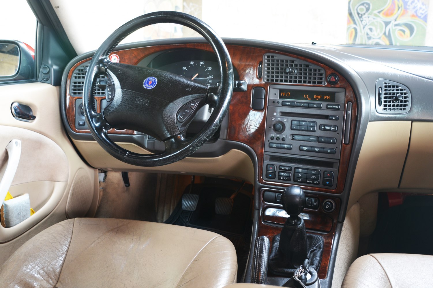 Steering wheel and wooden dashboard with manual transmission gearshift