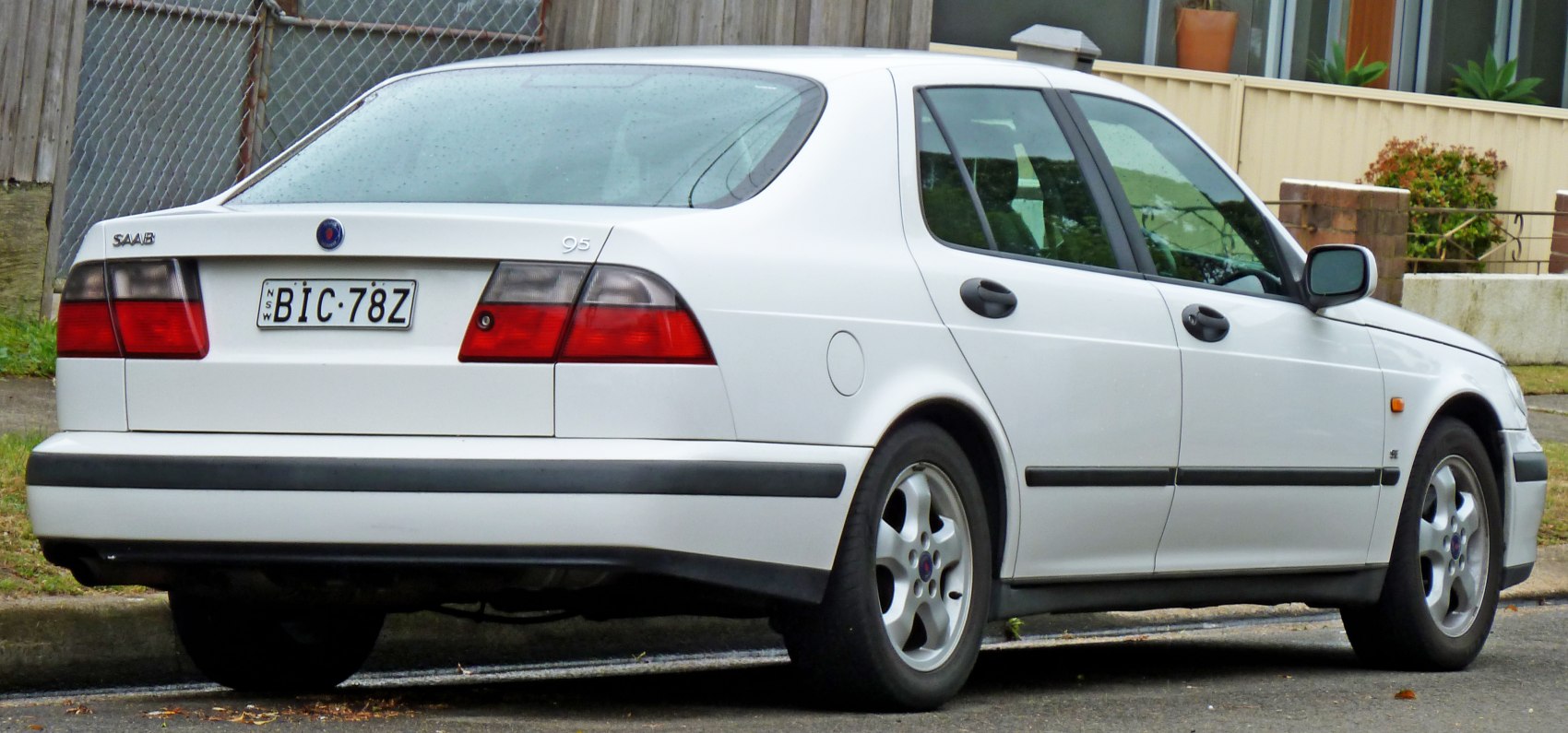Rear and side view of a white sedan with distinctive tail lights and clean lines