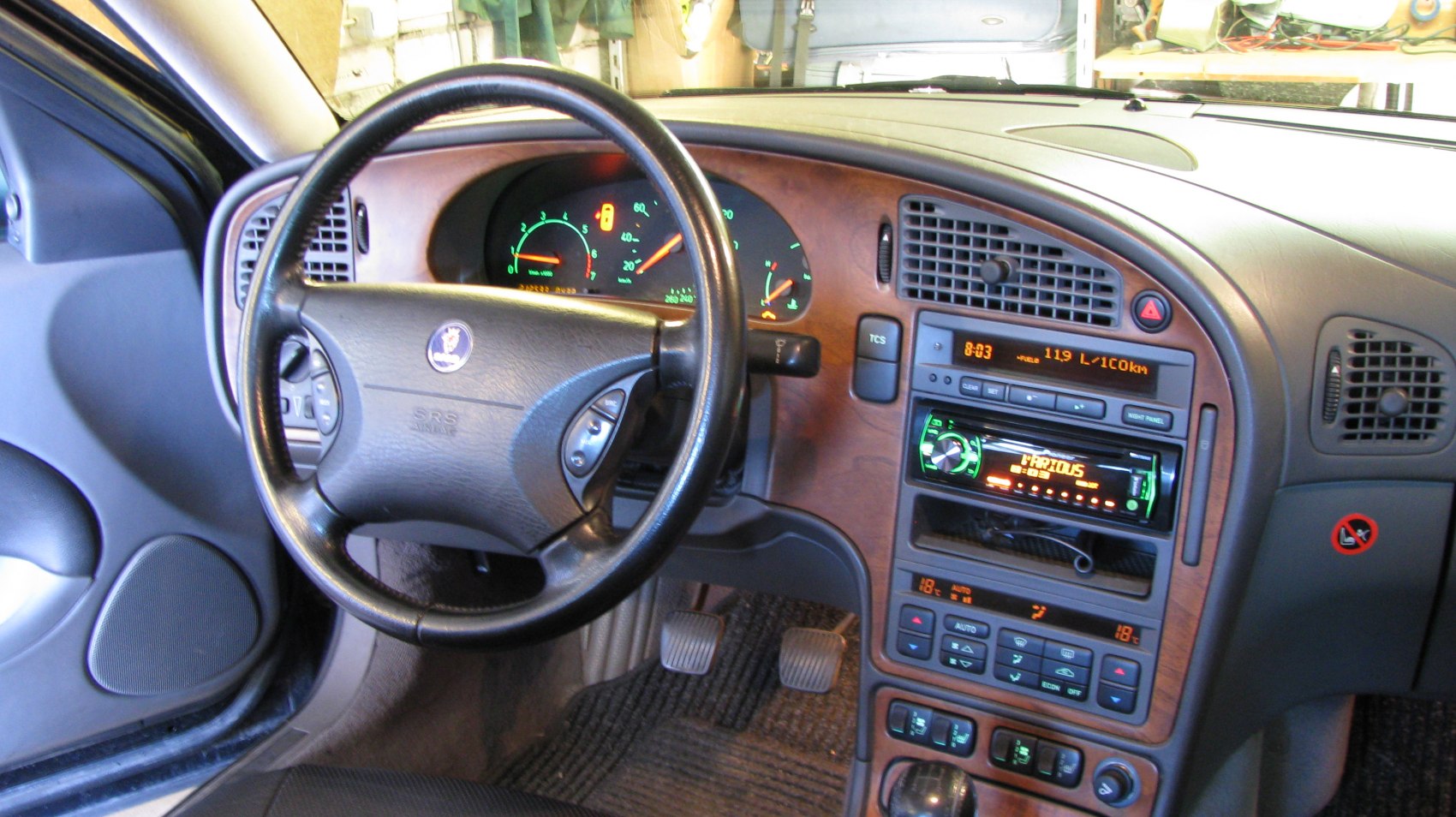 Wood-trimmed dashboard and steering wheel with controls