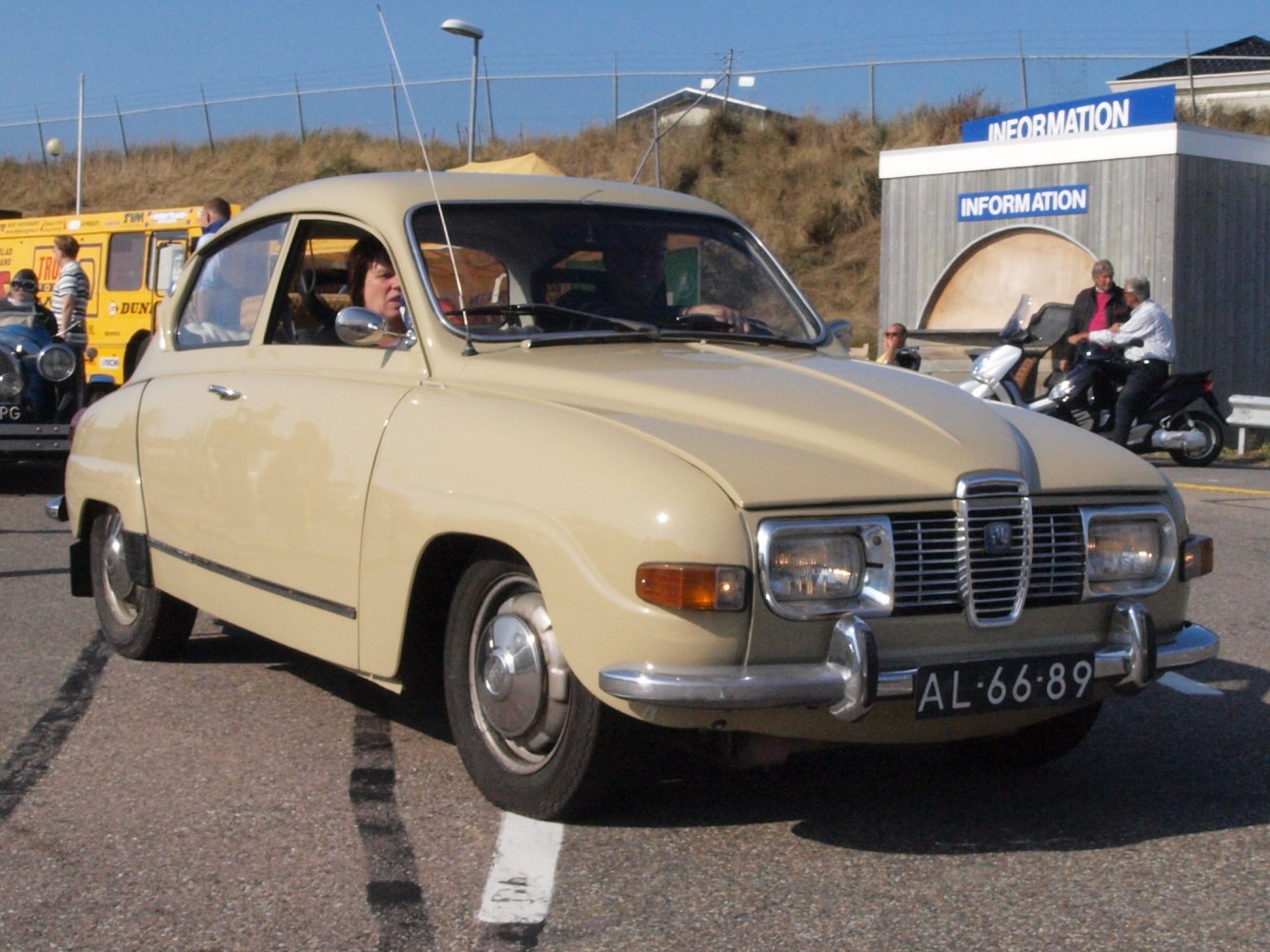 Front and side view of a vintage compact car with distinctive grille and rounded headlights