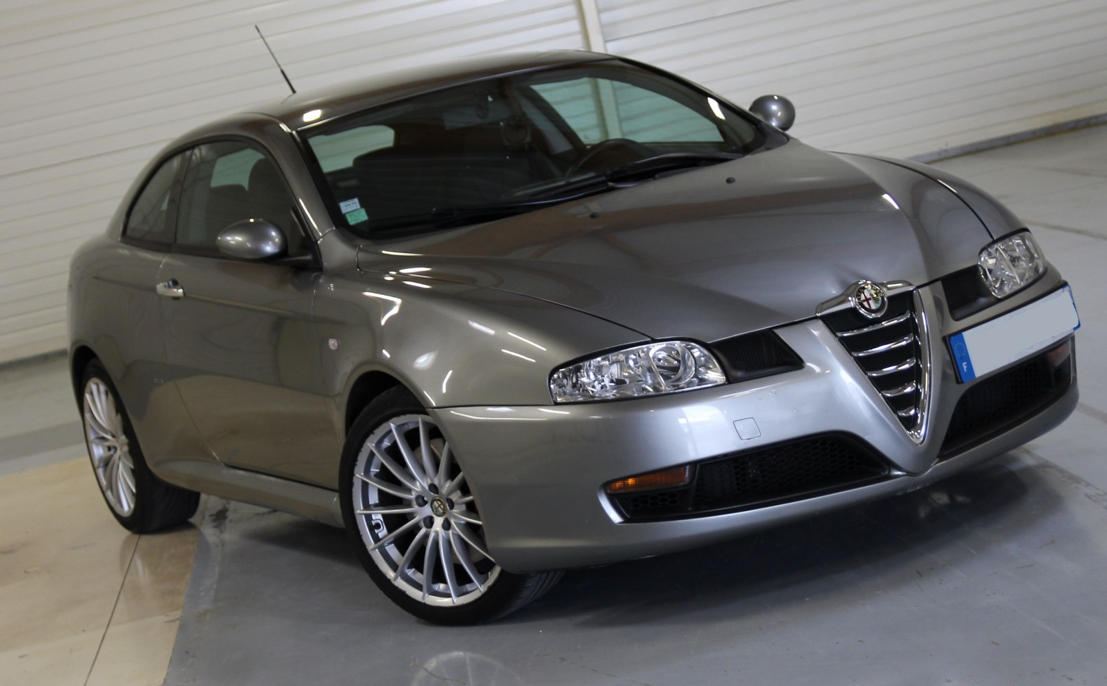 Silver coupe with front grille and multi-spoke alloy wheels