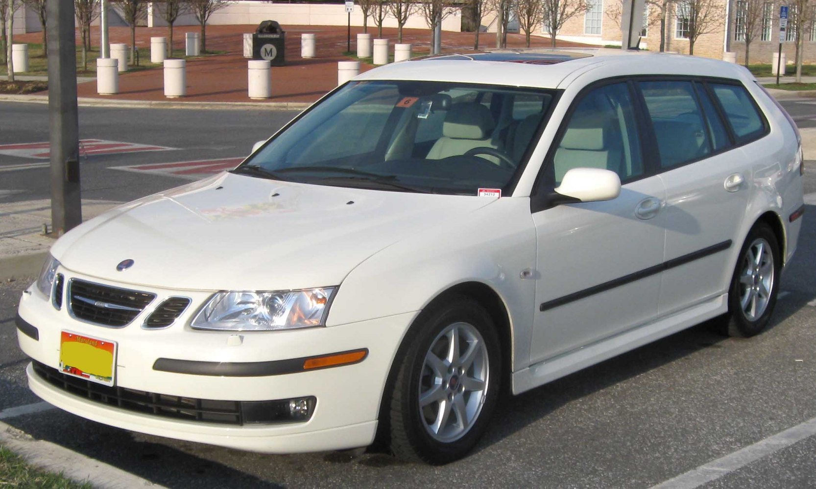 White wagon with alloy wheels and front side view.