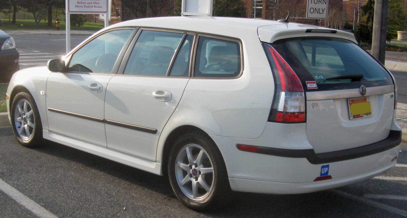 Station wagon rear side with lifted hatch and alloy wheels.