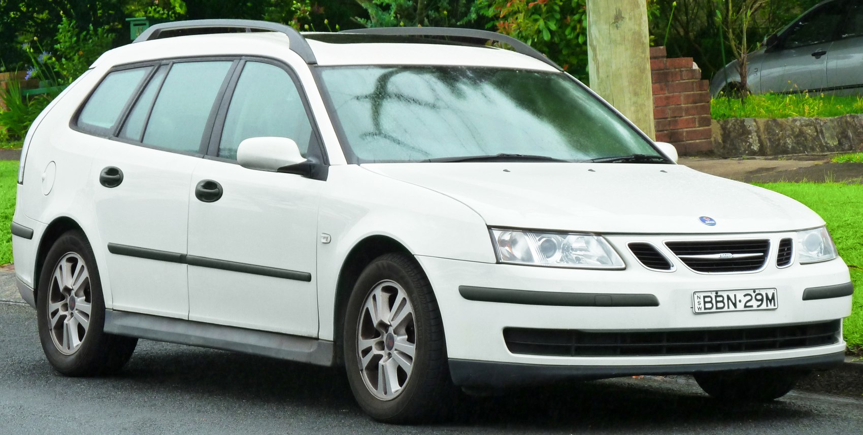 White station wagon with roof rails and alloy wheels.