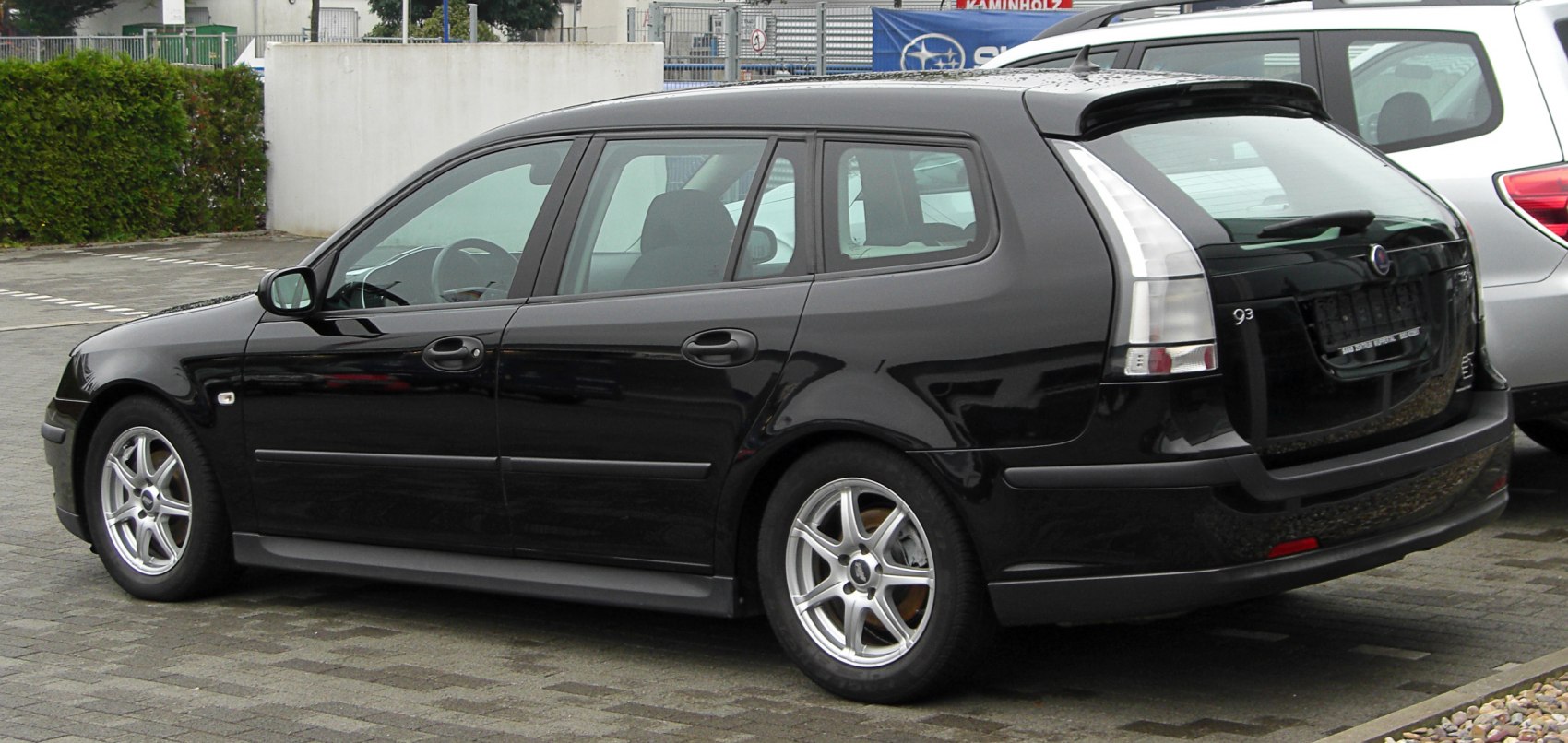 Black station wagon with distinctive vertical rear tail lights and alloy wheels