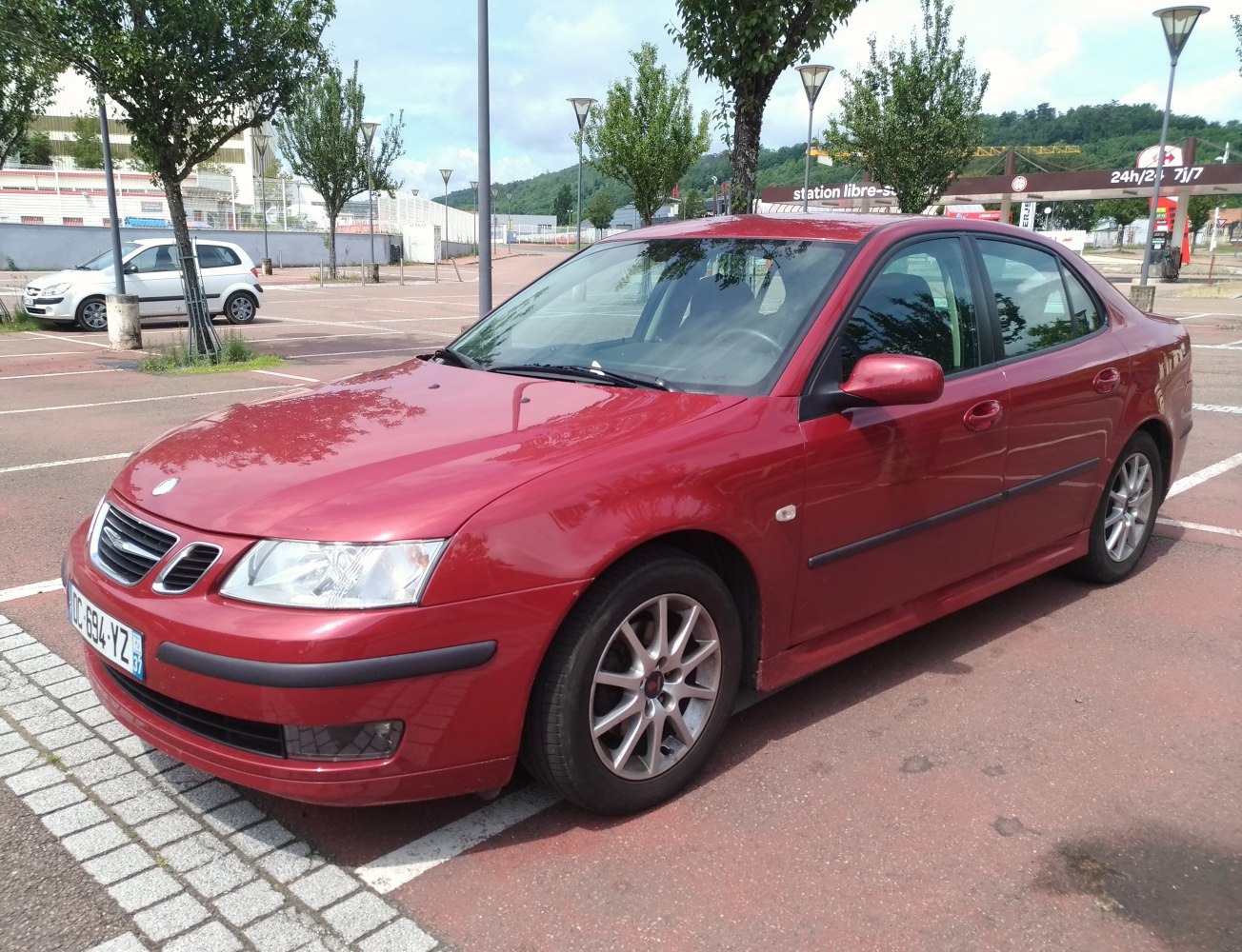 Red sedan with alloy wheels and black side trims