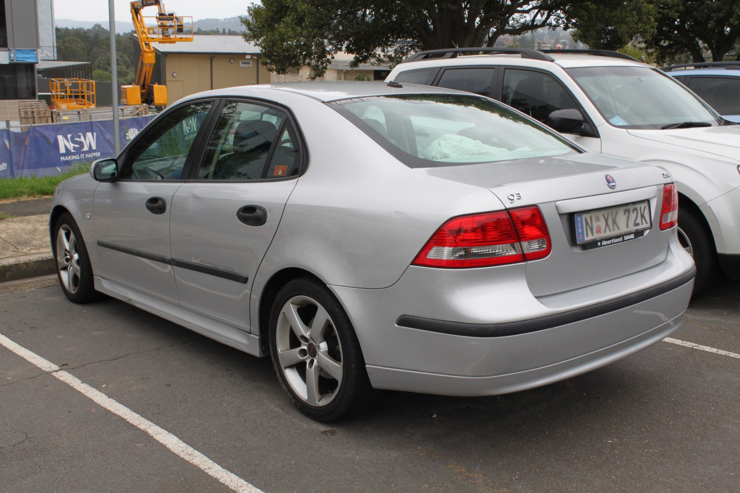 Rear side view of sedan with alloy wheels and tail lights