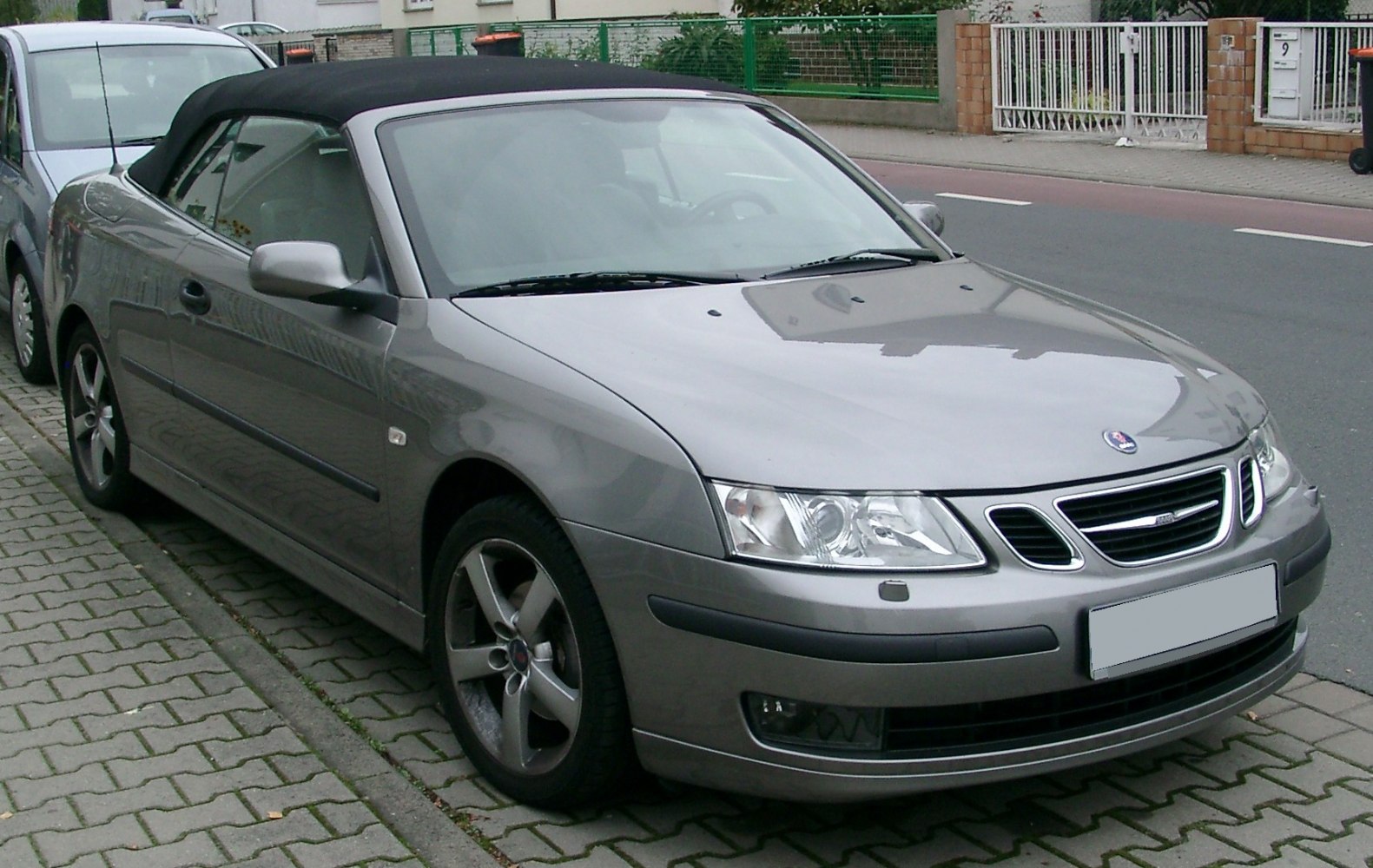 Front side view of a convertible with soft top and alloy wheels
