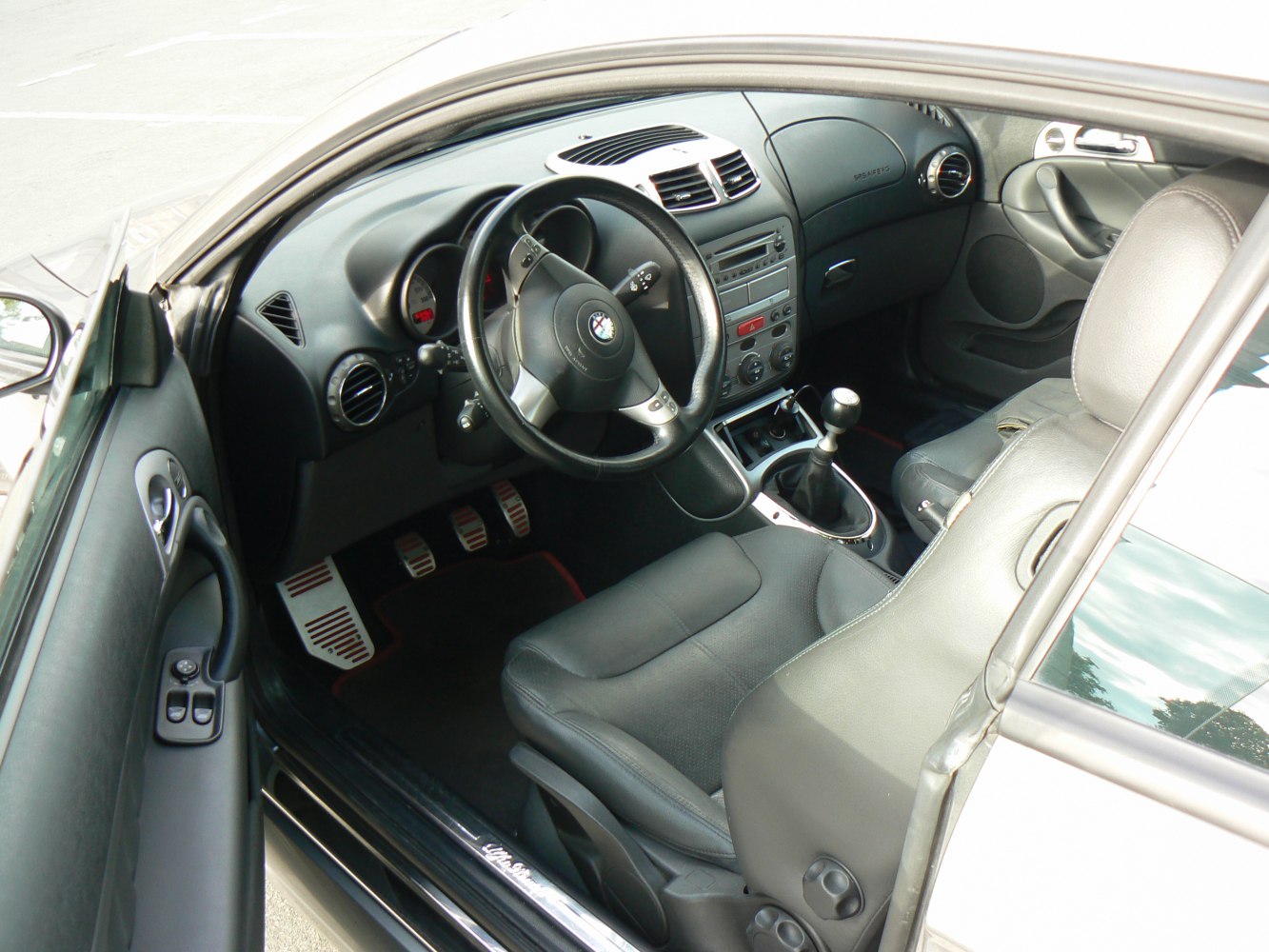Sporty car interior with manual gear lever and aluminum pedals