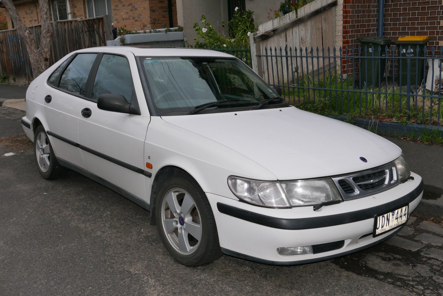 White 4-door sedan with distinctive front grille and alloy wheels