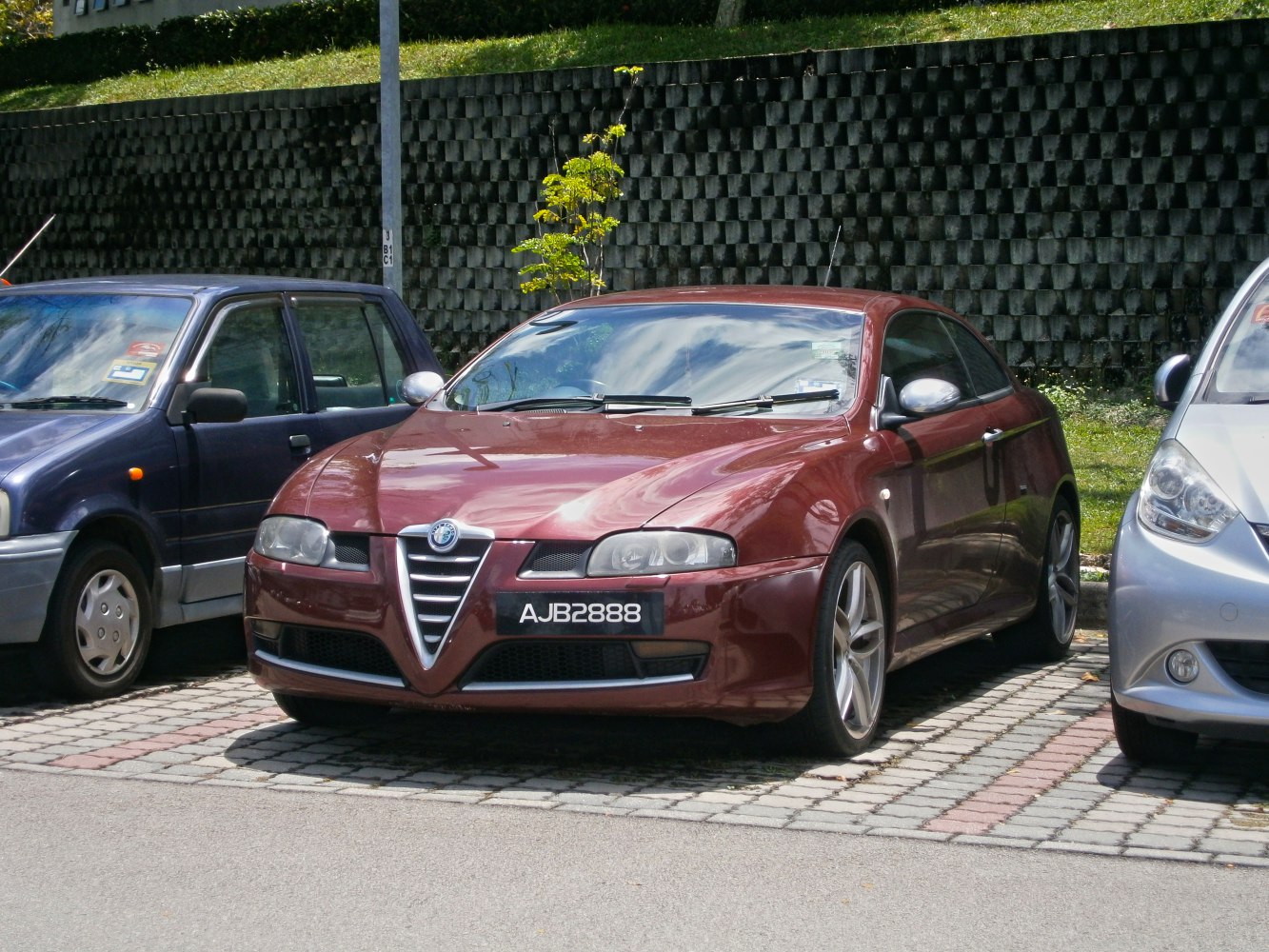 Sporty coupe front with V-shaped grille and sleek headlamps