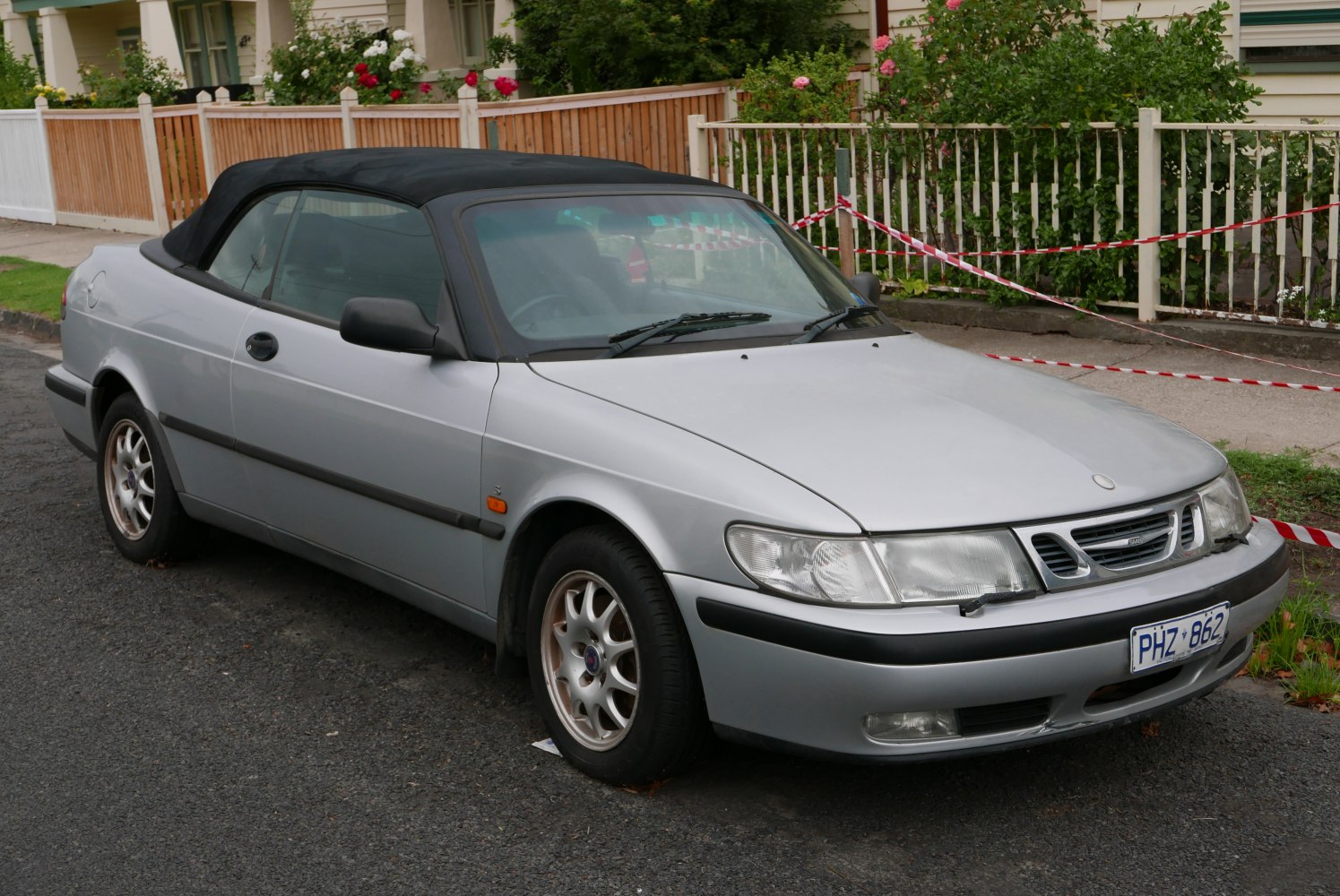 Silver convertible with black soft top and alloy wheels