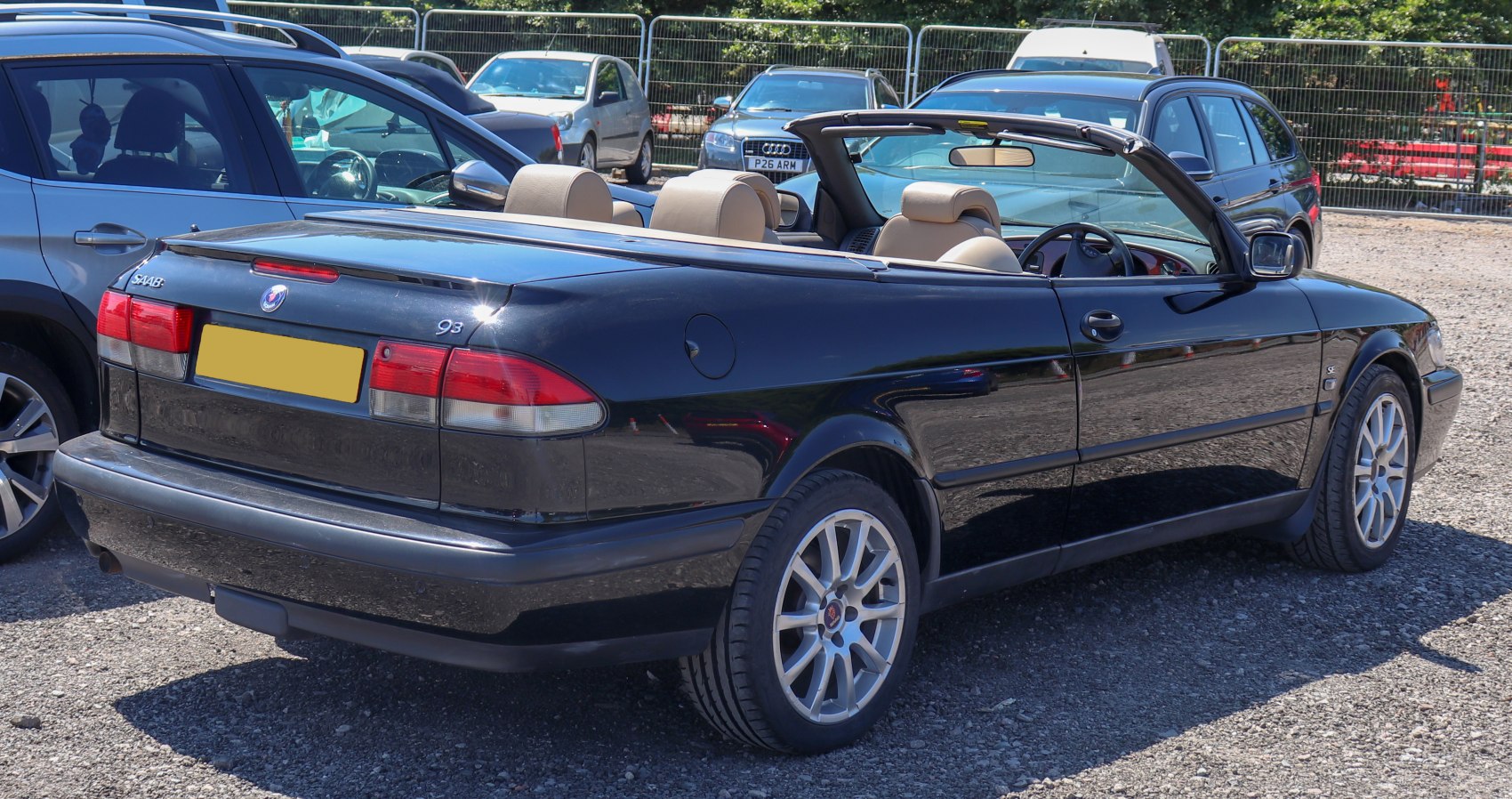 Black convertible with beige leather seats and alloy wheels