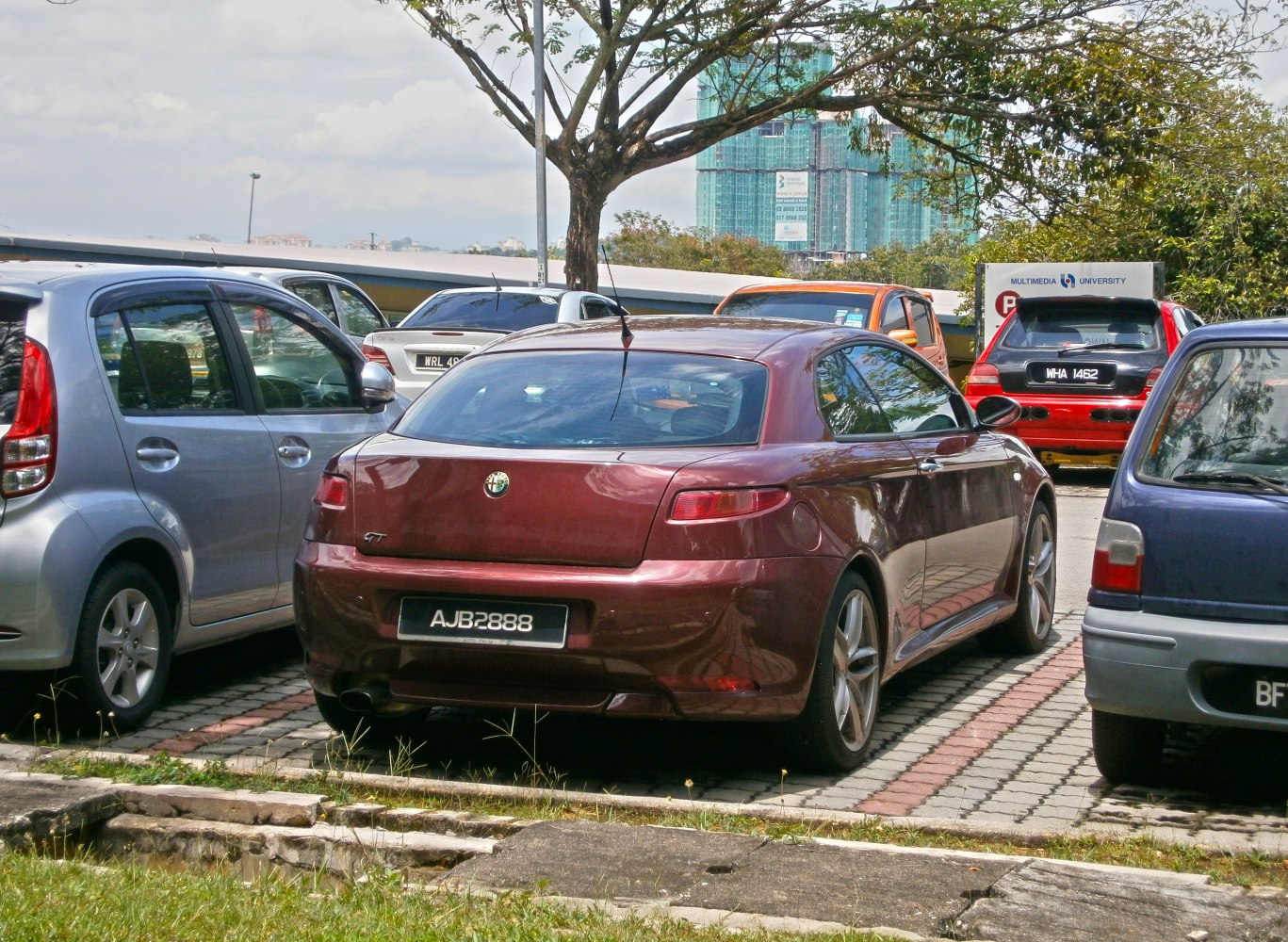 Rear view of a sports coupe with distinct narrow taillights and curved rear window.