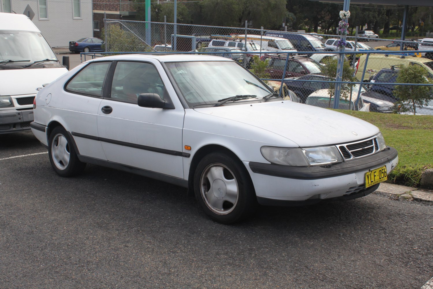 White two-door coupe with sleek lines and vintage alloy wheels from the 1990s.
