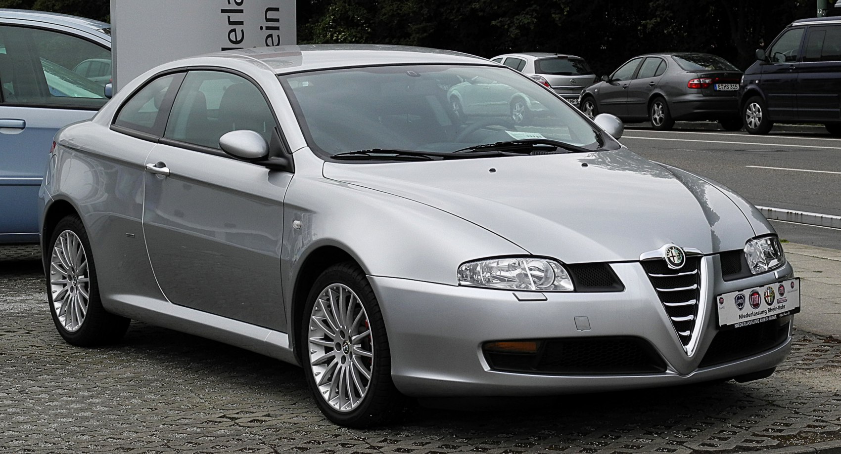 Silver coupe with distinctive front grille and sporty alloy wheels