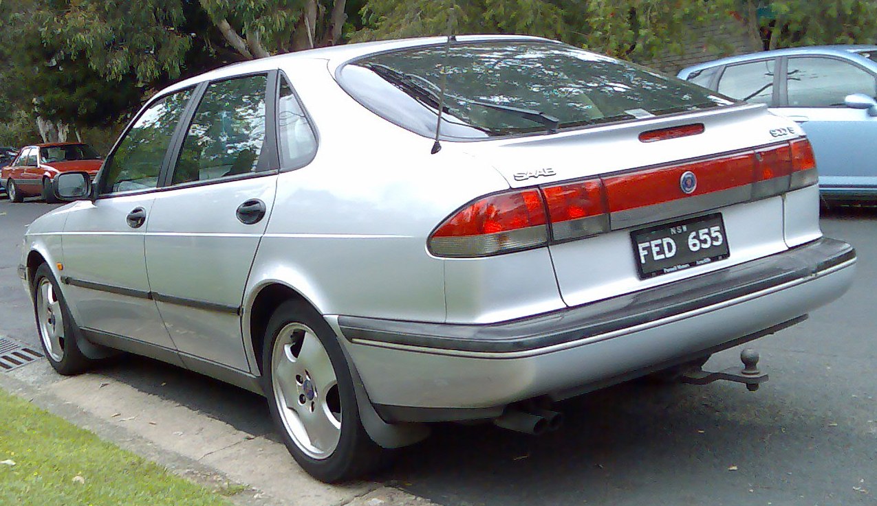 Silver sedan rear with distinctive tail lights and integrated spoiler