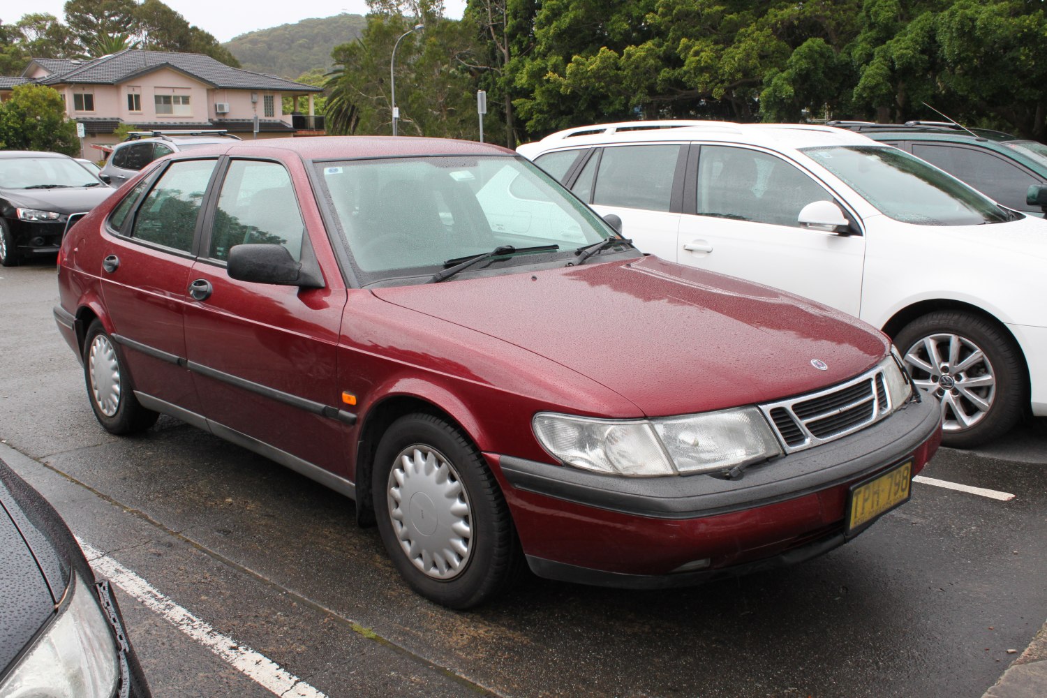 Red midsize sedan front and side view with distinct 1990s design.