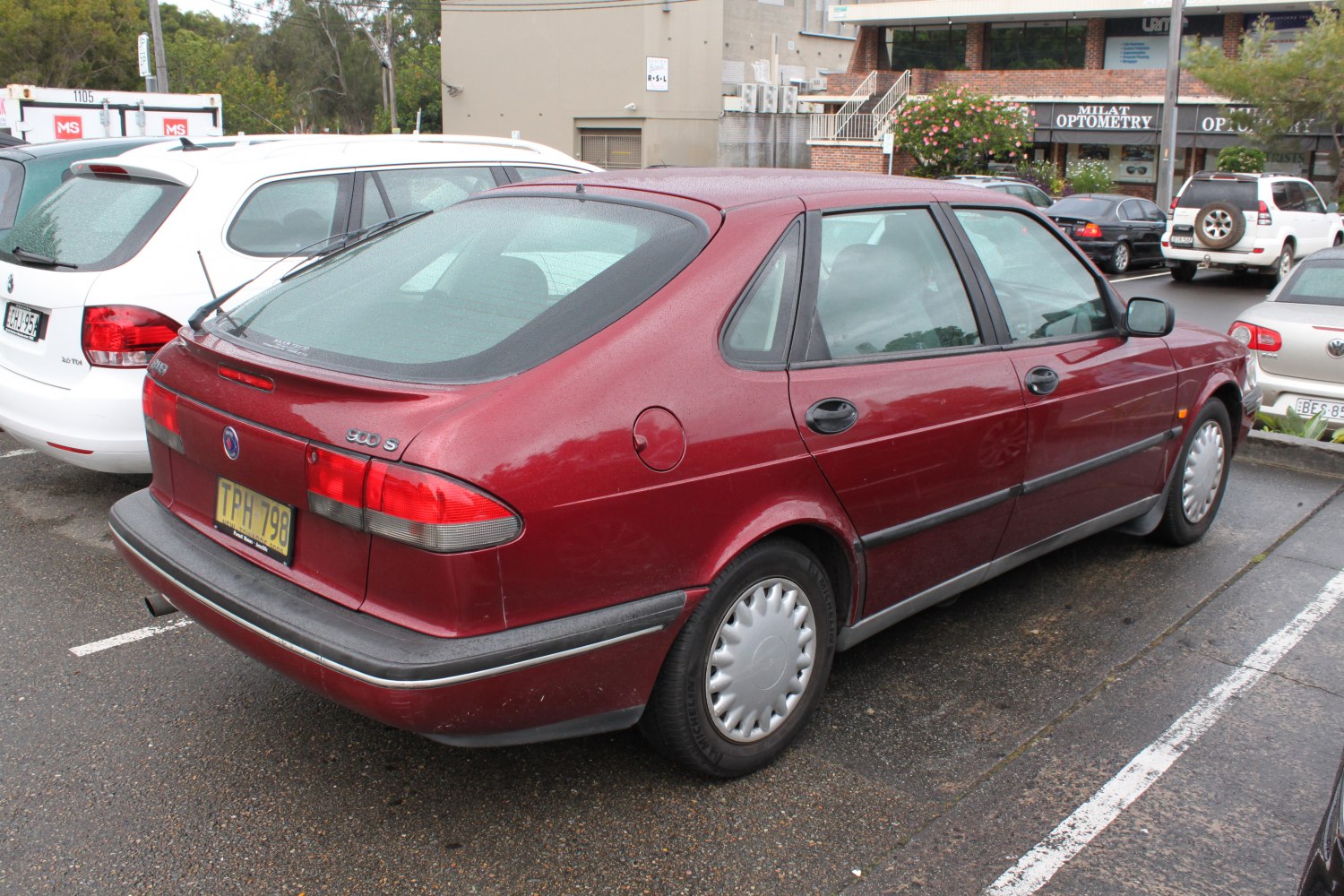 Rear view of a sedan showing distinctive taillights and rear window design.