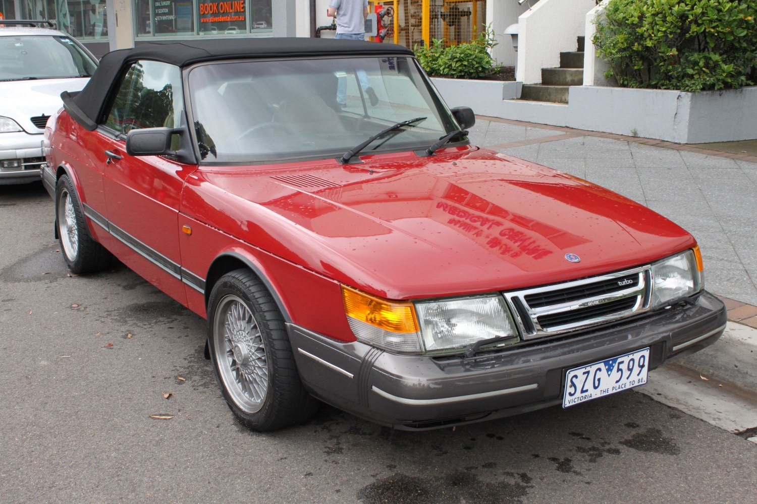 Red convertible with black soft top and alloy wheels