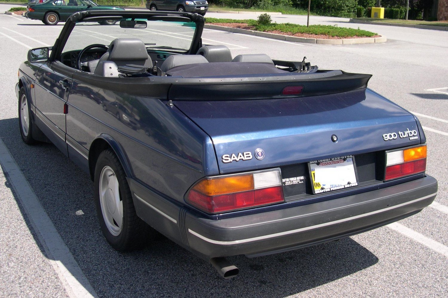 Rear view of a vintage convertible with turbo badge and open roof