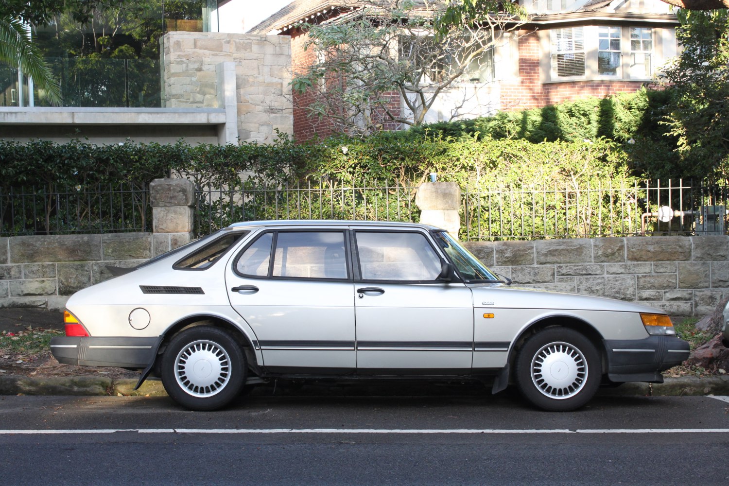 Side profile of a classic Saab hatchback with distinctive wheels.