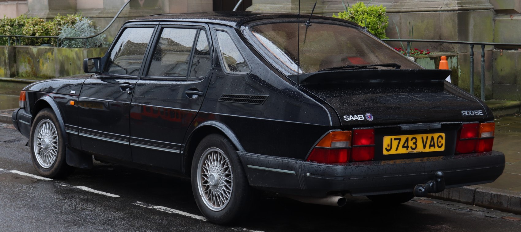 Rear and side view of a classic hatchback with alloy wheels and rear spoiler.