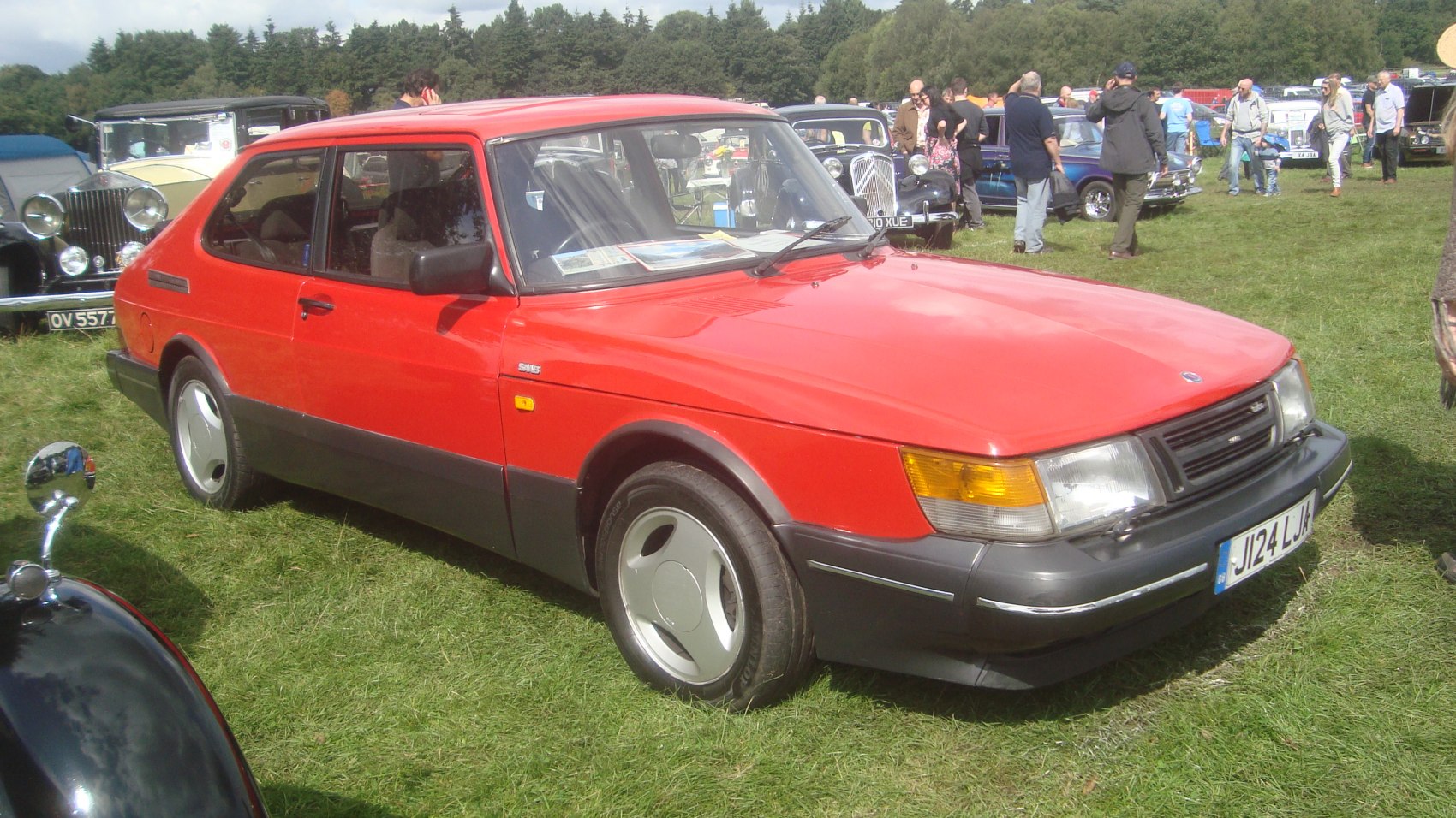Red red 1987 sedan side profile with black trim and amber signal