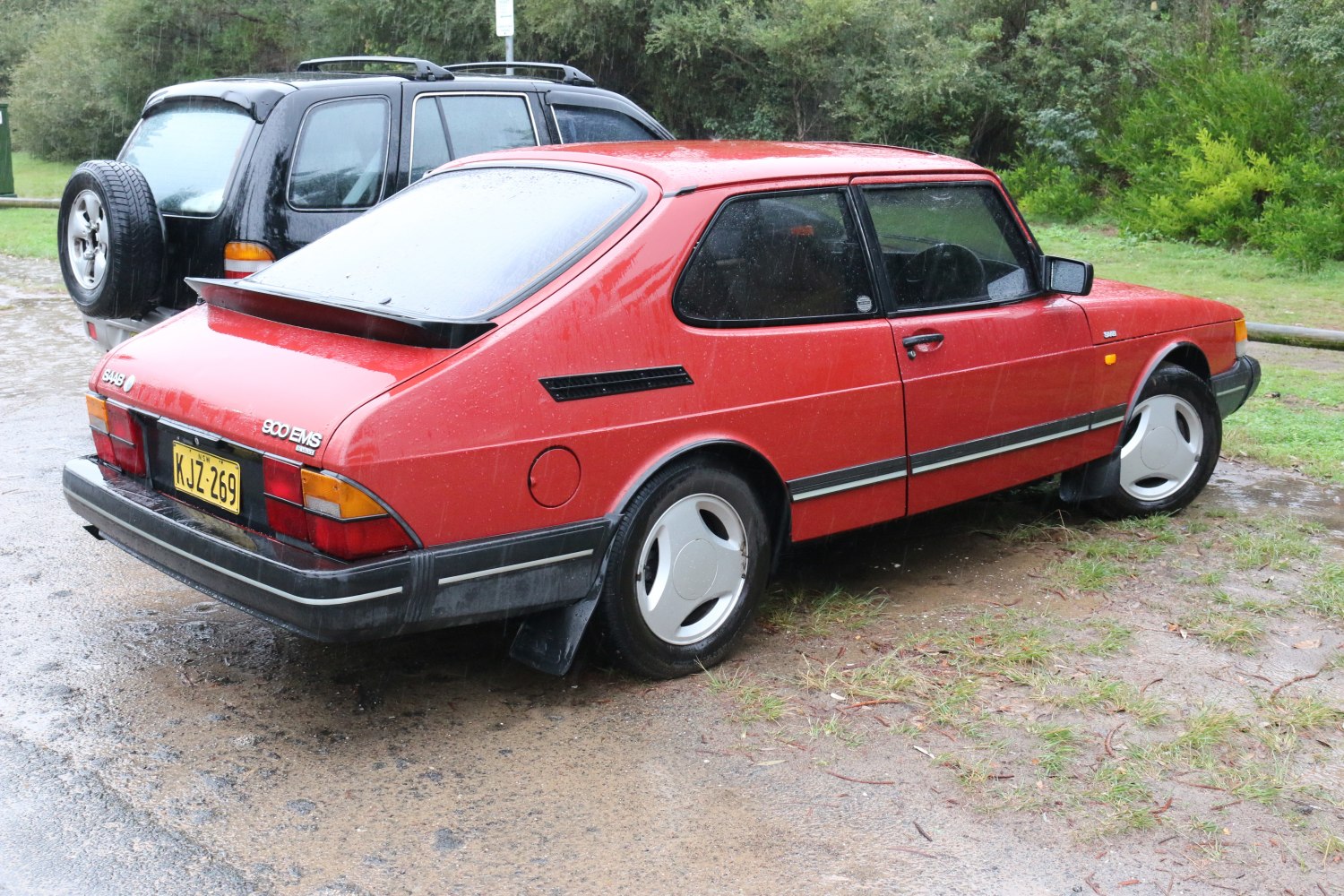 Compact hatchback with rear spoiler and three-spoke wheels