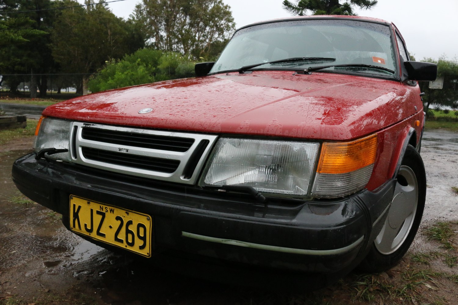 Close-up of classic car front with rectangular headlights and grille