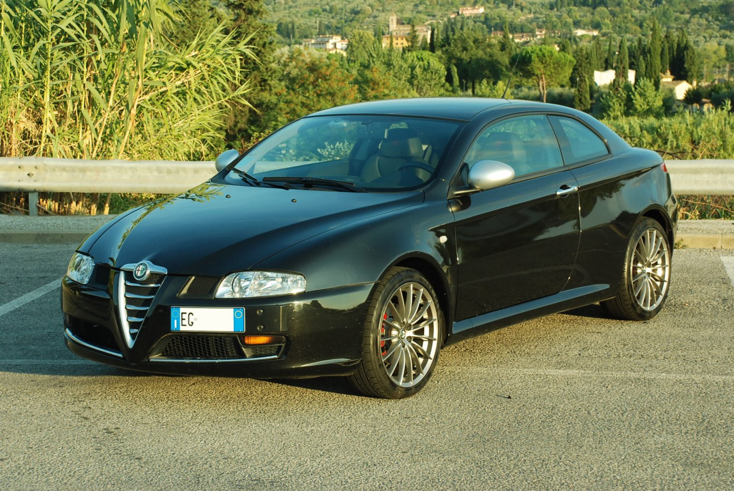 Front and side view of a sleek 2-door coupe with alloy wheels and aerodynamic design