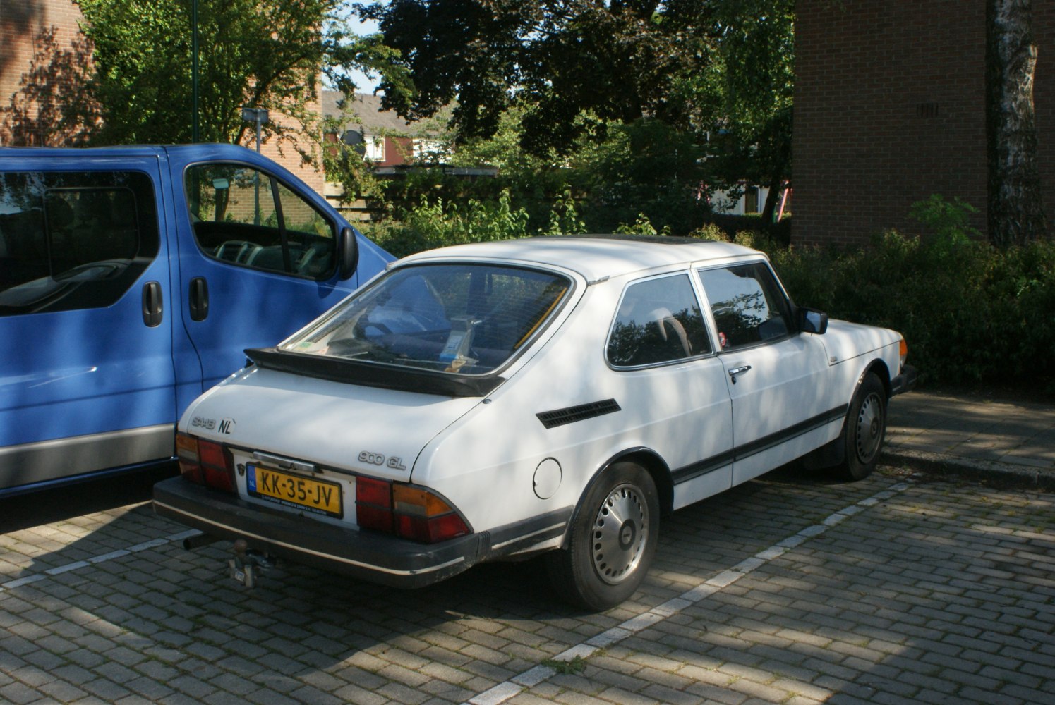 Vintage hatchback with rear spoiler and angular rear design.