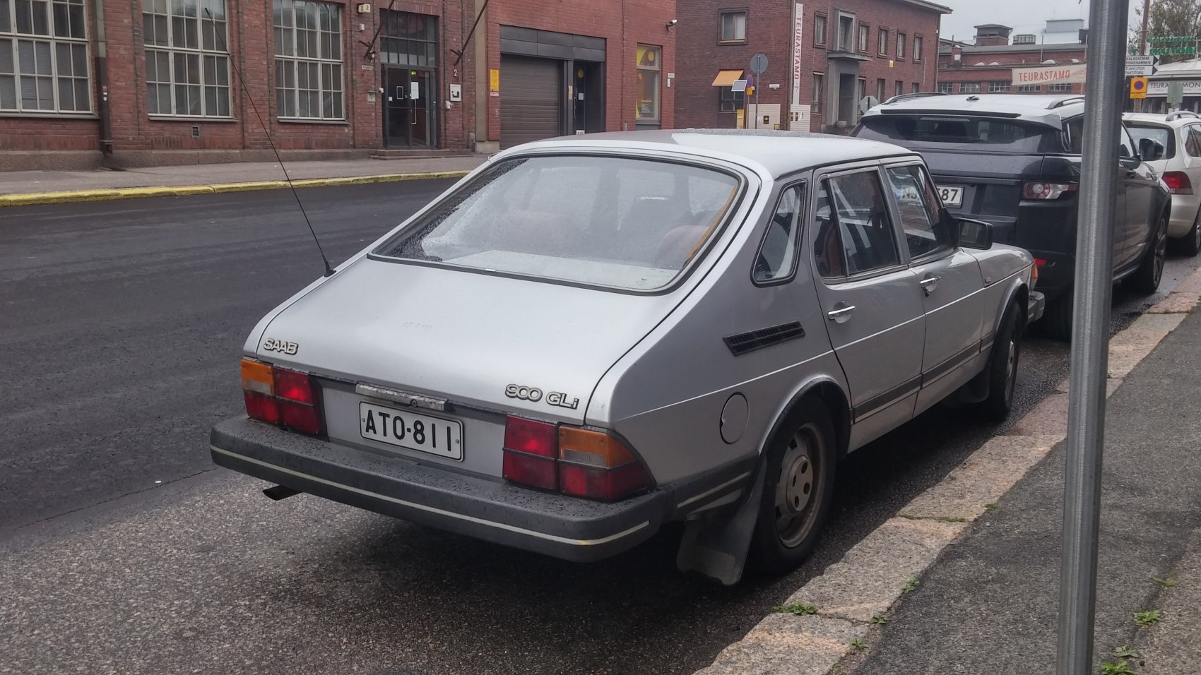 Rear and side view of a vintage hatchback with sloped back and rectangular tail lights