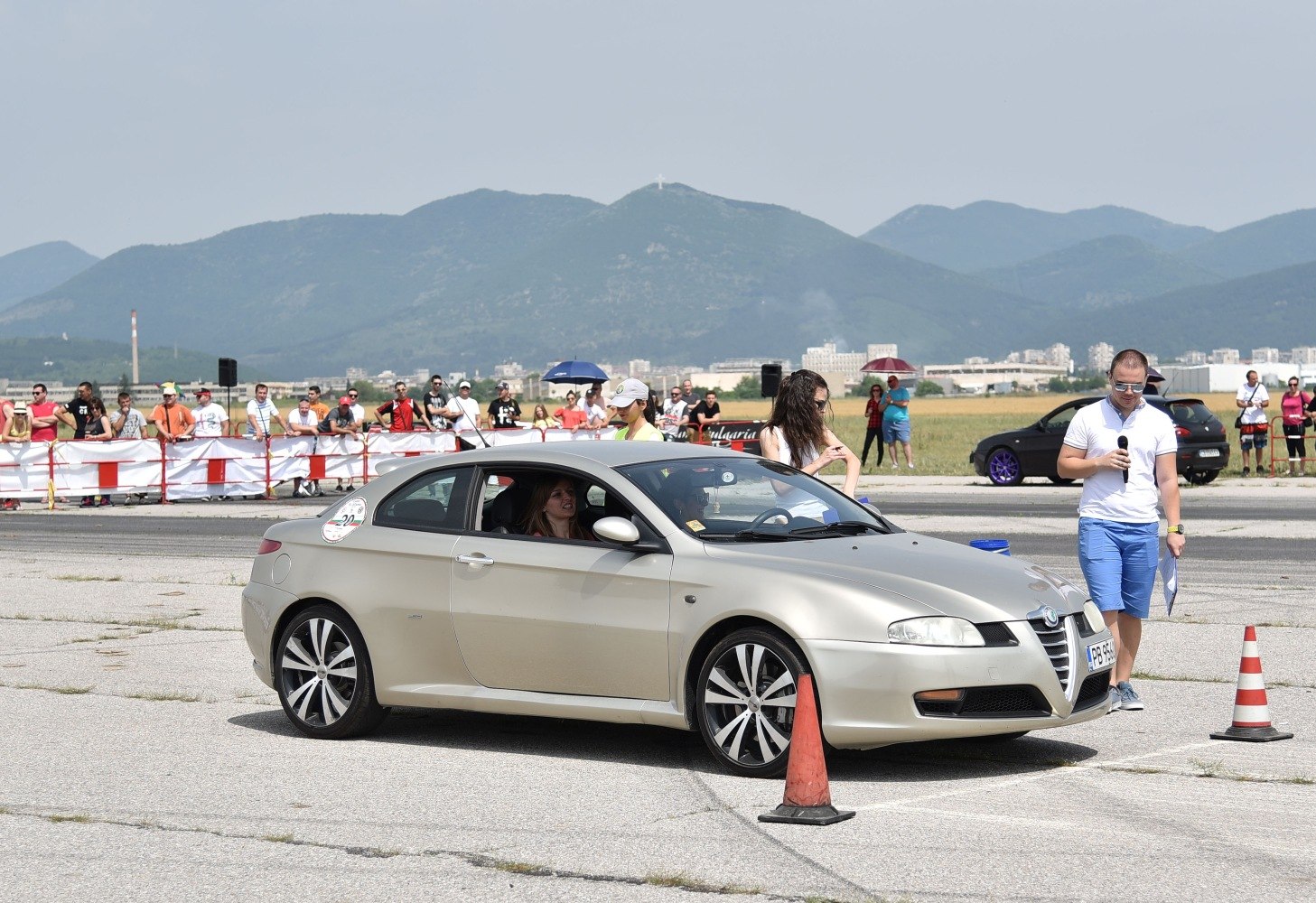 silver sporty coupe with alloy wheels in side profile