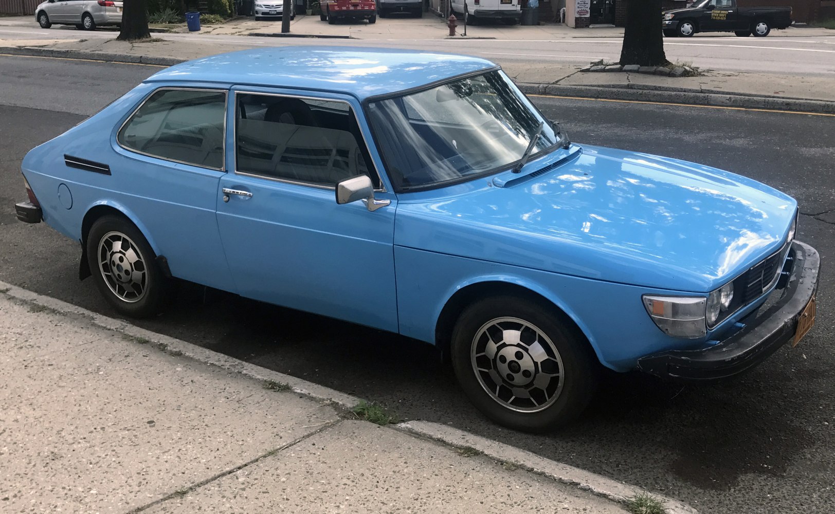Two-door vintage hatchback with alloy wheels and angular design