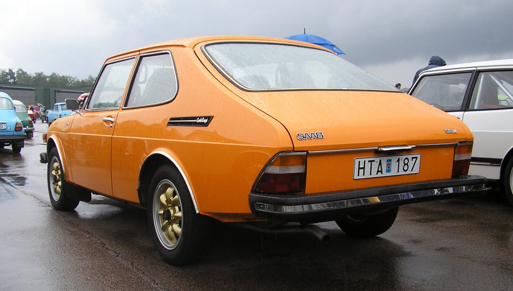 Rear 3-4 view of orange classic hatchback with distinctive sloping rear design